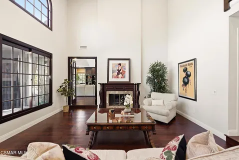 a living room with furniture fireplace and window