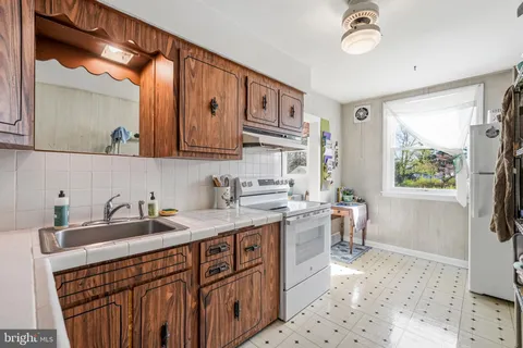 a kitchen with a sink stove and cabinets