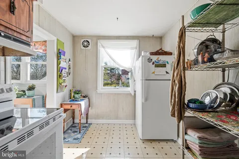 a kitchen with a refrigerator and a stove