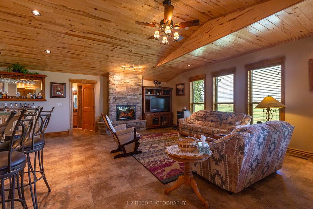 1296 O Road Loma, CO 81524 - Photo 11 of 41 a living room with furniture a flat screen tv and floor to ceiling window
