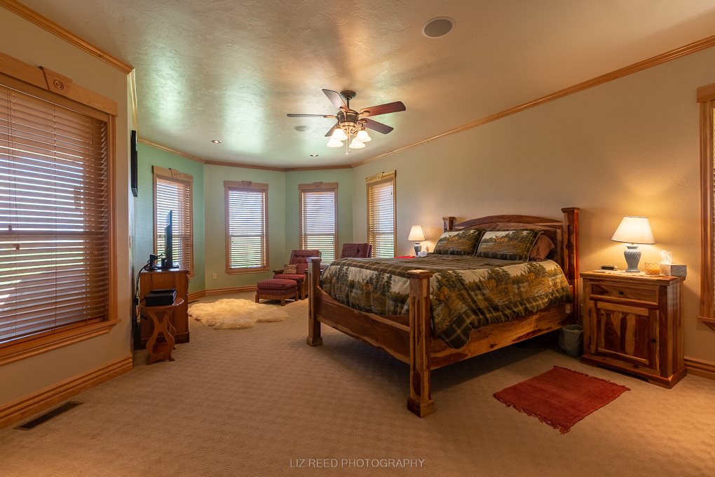1296 O Road Loma, CO 81524 - Photo 12 of 41 a bedroom with a bed and dresser with mirror