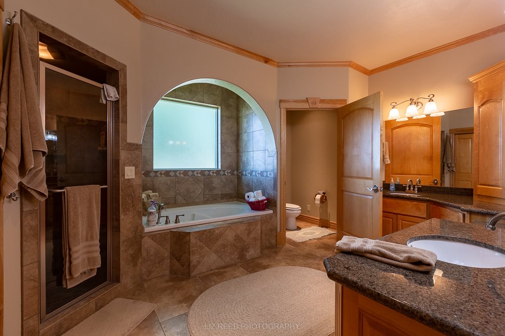 1296 O Road Loma, CO 81524 - Photo 13 of 41 a bathroom with a granite countertop tub a sink and a mirror