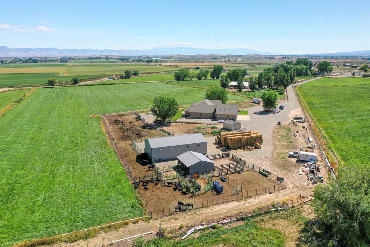 1296 O Road Loma, CO 81524 - Photo 2 of 41 an aerial view of a house with garden space and ocean view