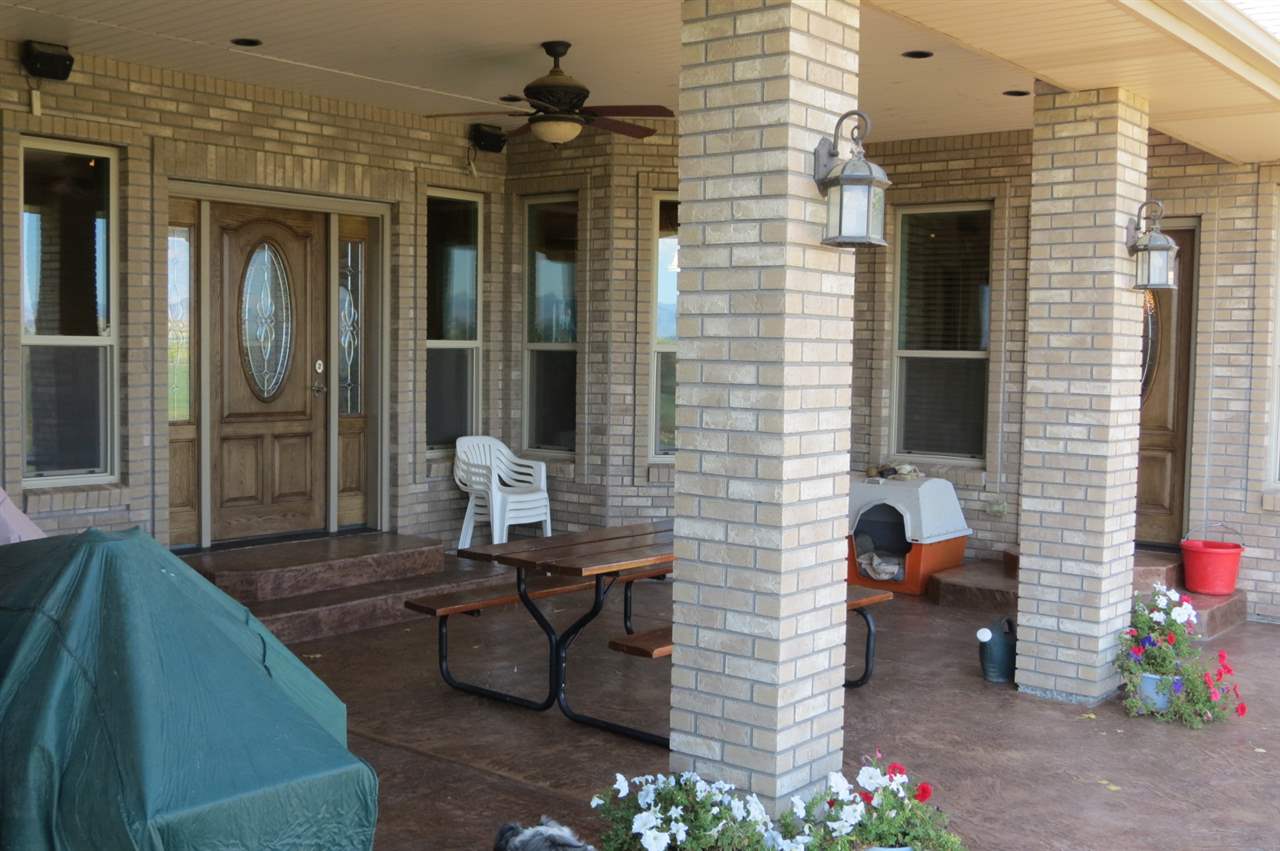 1296 O Road Loma, CO 81524 - Photo 24 of 41 a view of a porch with chairs and a potted plant