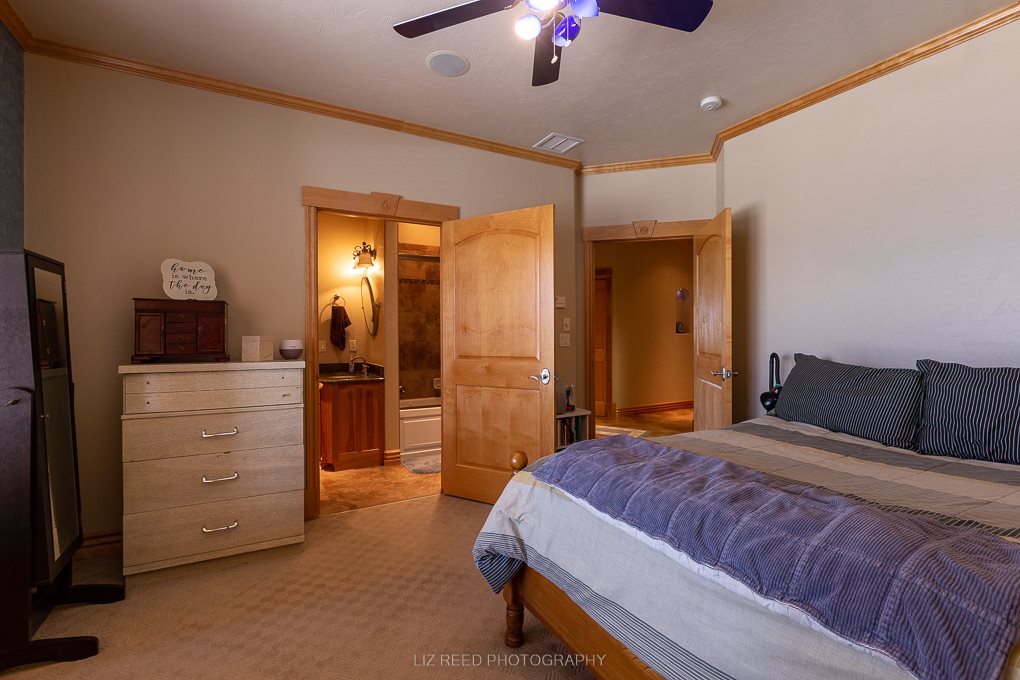 1296 O Road Loma, CO 81524 - Photo 26 of 41 a bedroom with a bed and a chandelier