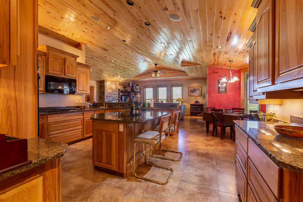 1296 O Road Loma, CO 81524 - Photo 8 of 41 a view of a patio with dining table and chairs with wooden floor and fence