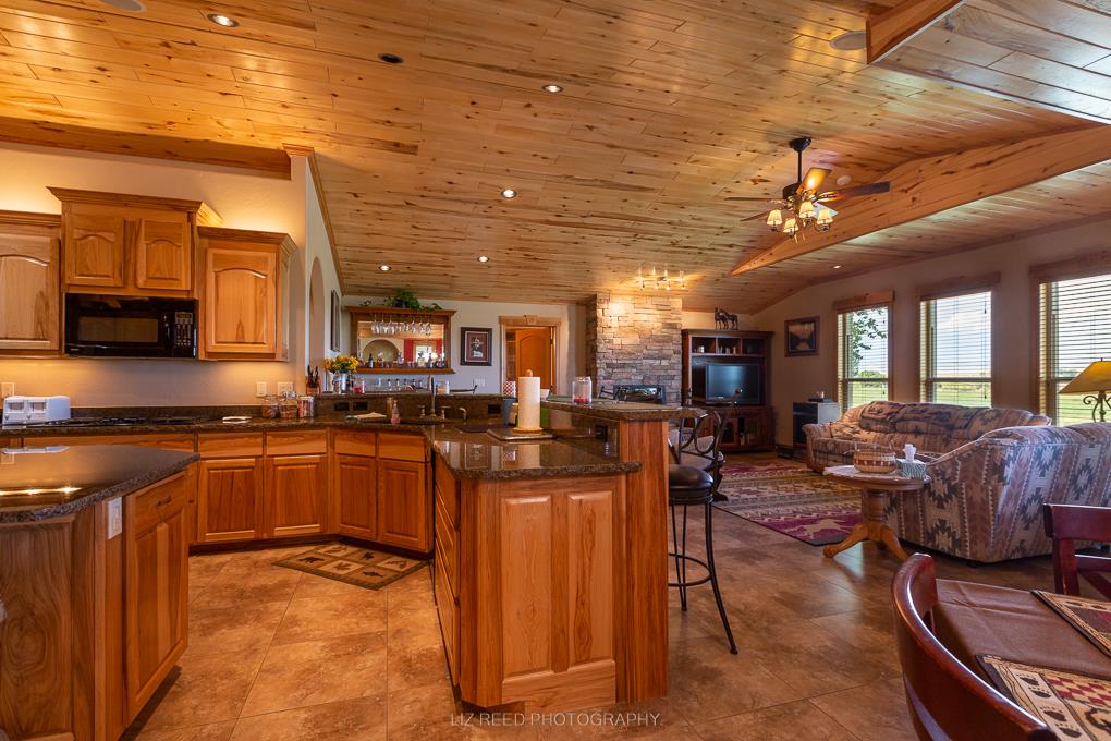 1296 O Road Loma, CO 81524 - Photo 9 of 41 a kitchen with stainless steel appliances granite countertop a stove a sink dishwasher and cabinets with wooden floor