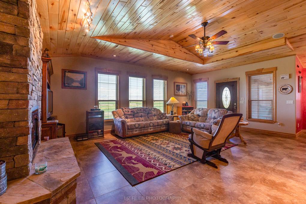 1296 O Road Loma, CO 81524 - Photo 10 of 41 a living room with furniture a rug and a chandelier