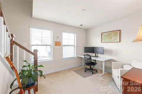 a view of a livingroom with workspace and a window