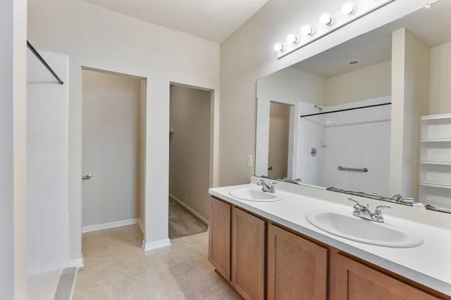 a bathroom with a double vanity sink mirror and double