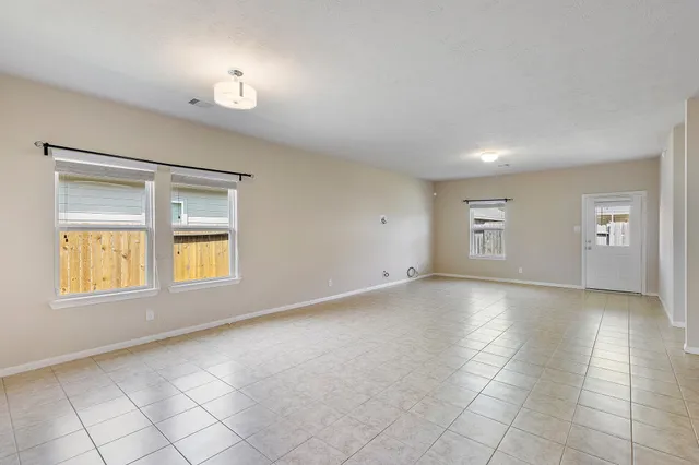 an empty room with a empty space and windows