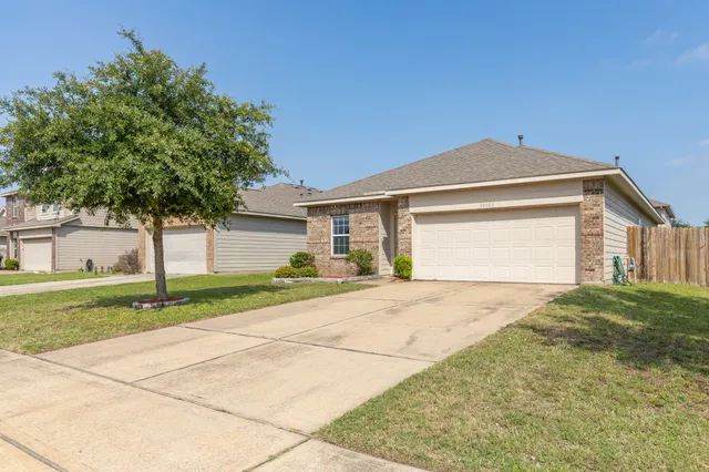 a front view of a house with a yard and garage