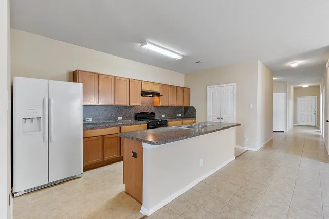 a kitchen with stainless steel appliances a refrigerator sink and cabinets