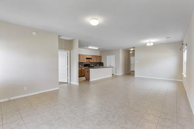 a view of kitchen with refrigerator sink and cabinets