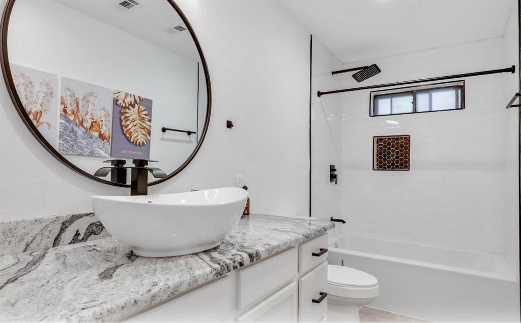 5041 Thunder Road Dallas, TX 75244 - Photo 11 of 20 a bathroom with a granite countertop sink a toilet and bathtub