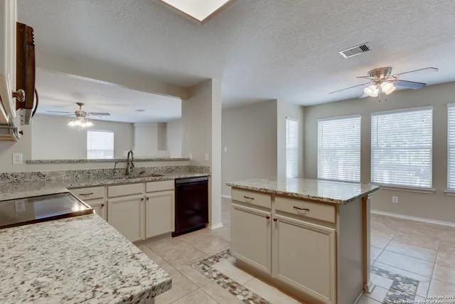 a large kitchen with kitchen island a sink stainless steel appliances and cabinets