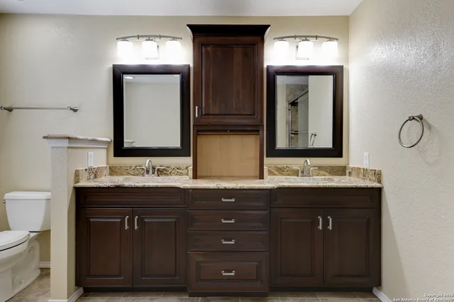 a bathroom with a double vanity sink and a mirror