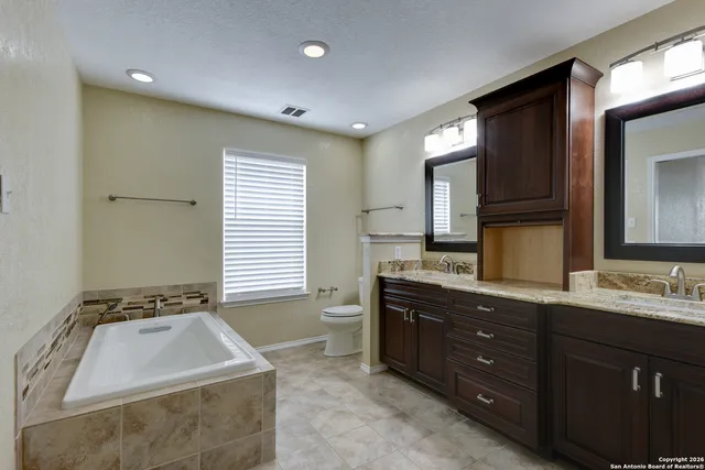 a en suite bathroom with a sink and a mirror