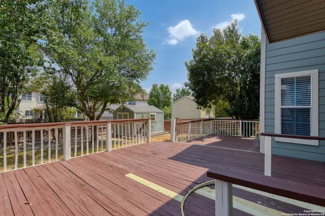 a view of a wooden deck and a backyard