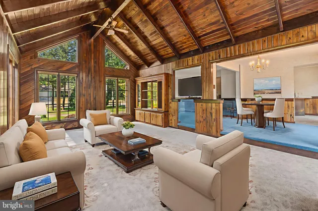 a living room with furniture and a view of kitchen