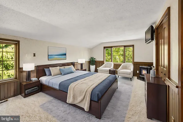 a spacious bedroom with a bed and a large window