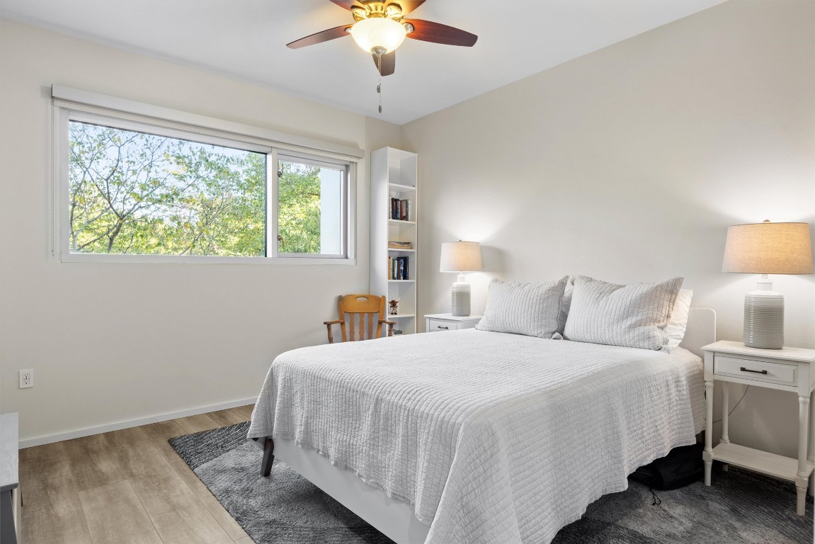 1600 Barton Springs Road, Unit 4205 Austin, TX 78704 - Photo 24 of 37 a bedroom with a bed and a chandelier