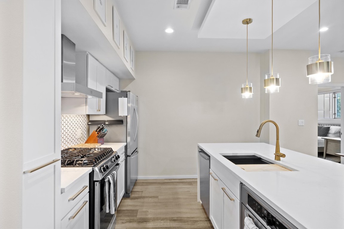 1600 Barton Springs Road, Unit 4205 Austin, TX 78704 - Photo 6 of 37 a kitchen that has a sink a stove and a refrigerator