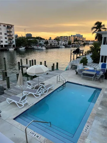 a view of a terrace with seating area and water view