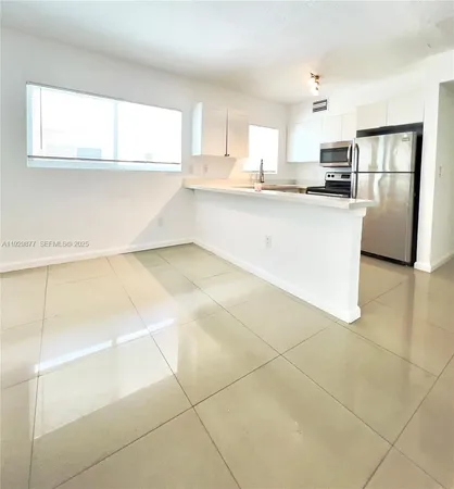 a kitchen with stainless steel appliances granite countertop a sink and a stove top oven