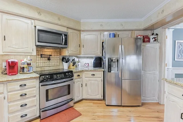a kitchen with stainless steel appliances a refrigerator stove and microwave