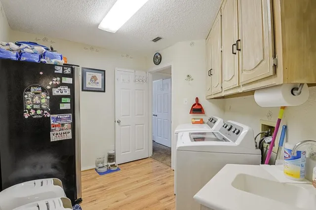 a utility room with sink dryer and washer