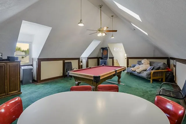 a living room with furniture a rug and gym equipment