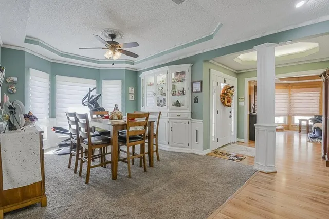 a view of a dining room with furniture and chandelier