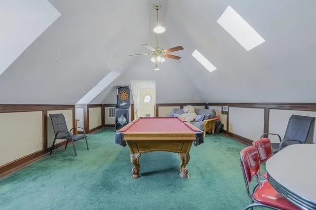 a living room with furniture and a pool table