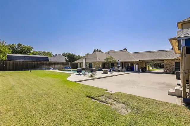 a view of swimming pool with outdoor seating and a garden