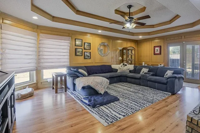 a living room with furniture and a wooden floor