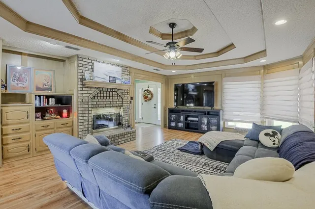 a living room with furniture a fireplace and a flat screen tv