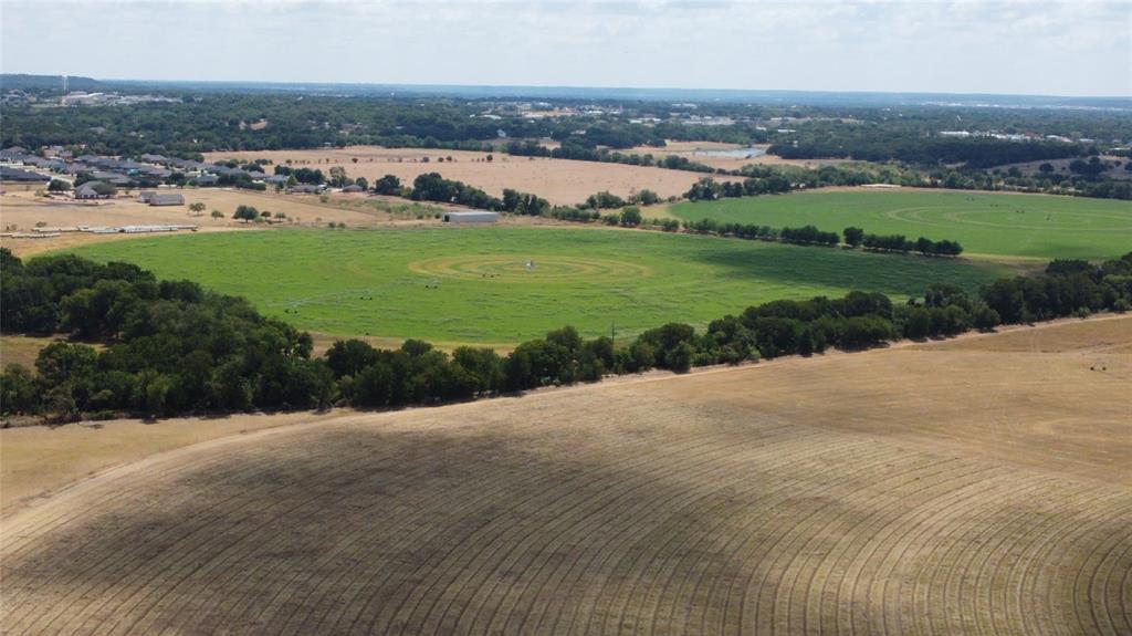 410 State School Road Gatesville, TX 76528 - Photo 6 of 39 Expansive rural landscape featuring fields with varied vegetation and distant residential developments