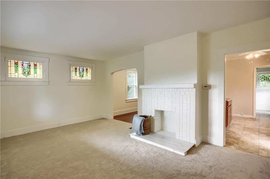 3990 Drexel Road Pittsburgh, PA 15212 - Photo 5 of 25 Living room with brand new carpeting and stained glass windows. Hardwood flooring under carpet.
