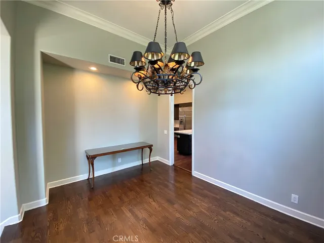 a view of a room with a potted plant and wooden floor