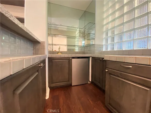 a kitchen with a sink and wooden floor