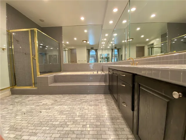 a bathroom with a sink a shower and a mirror