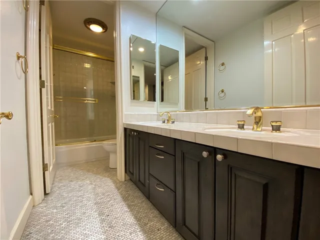 a bathroom with a sink double vanity and a shower