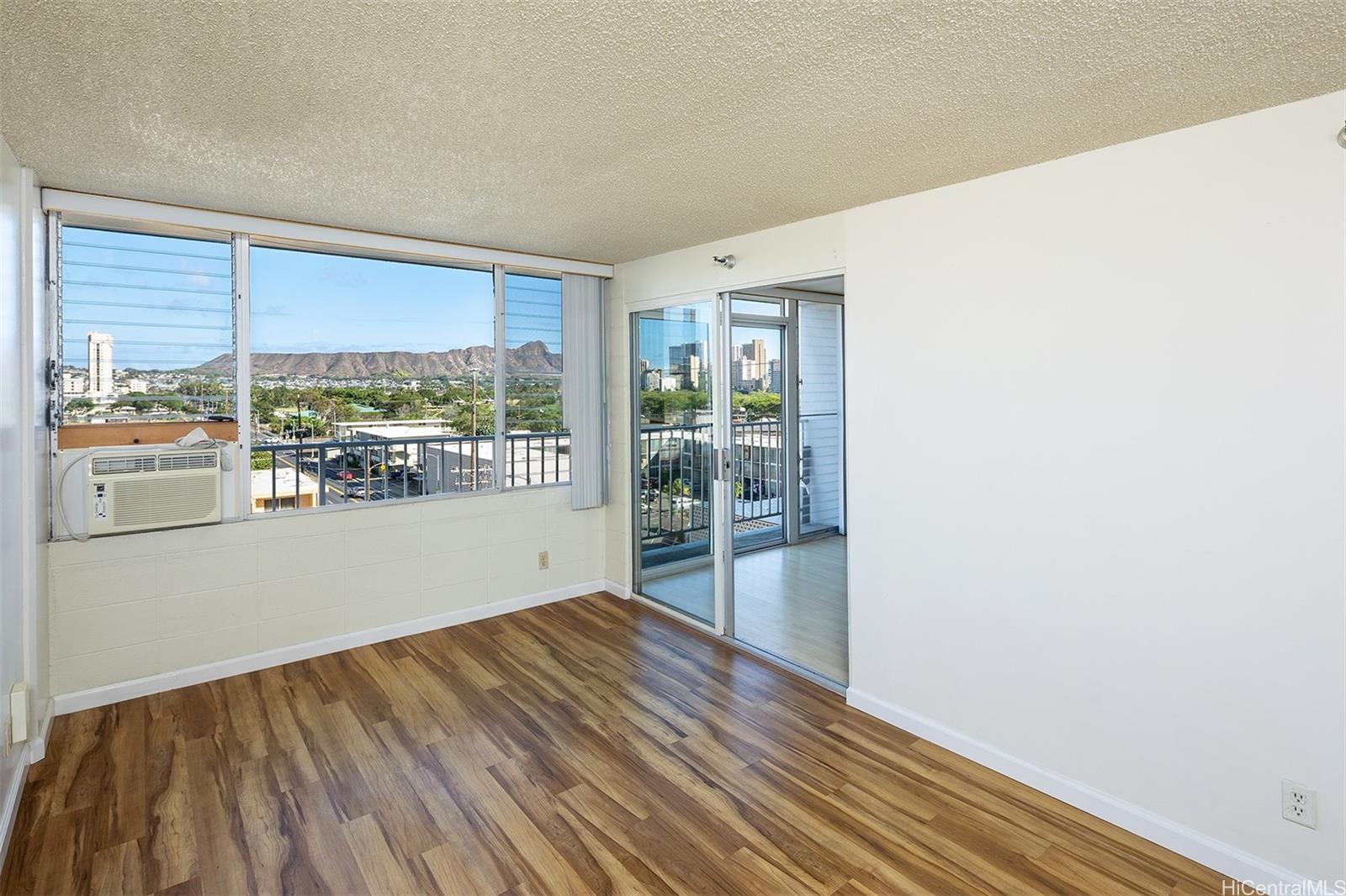 2542 Date Street, Unit 401 Honolulu, HI 96826 - Photo 1 of 1 a view of an empty room with wooden floor and a window
