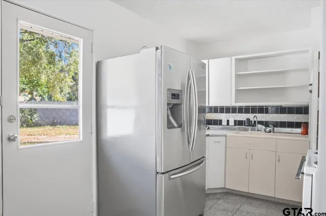 a white refrigerator freezer sitting inside of a kitchen