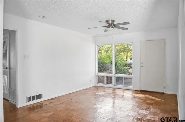 a view of an empty room with a window