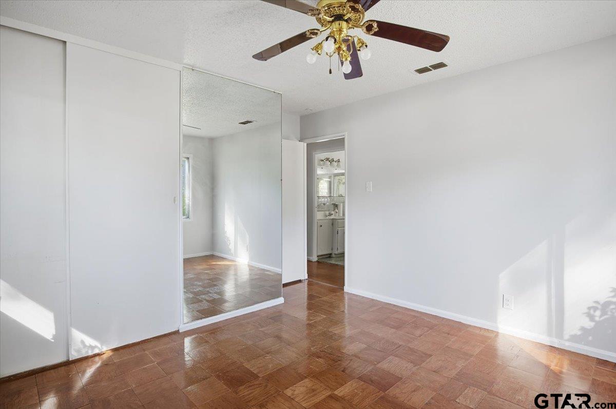 1835 Melba Drive Tyler, TX 75701 - Photo 10 of 28 an empty room with closet and a chandelier fan