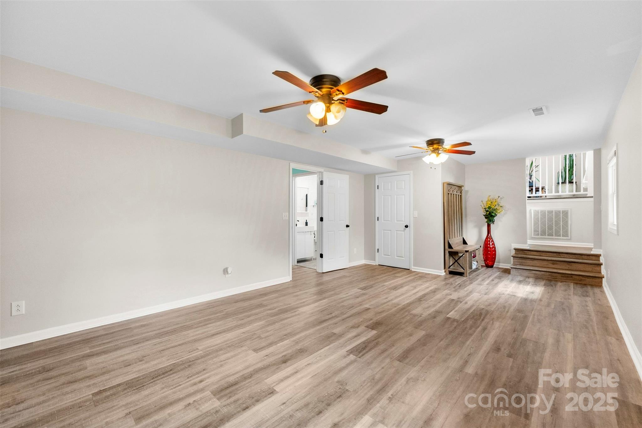 1822 North New Hope Road Gastonia, NC 28054 - Photo 12 of 47 a view of a livingroom with wooden floor and a ceiling fan