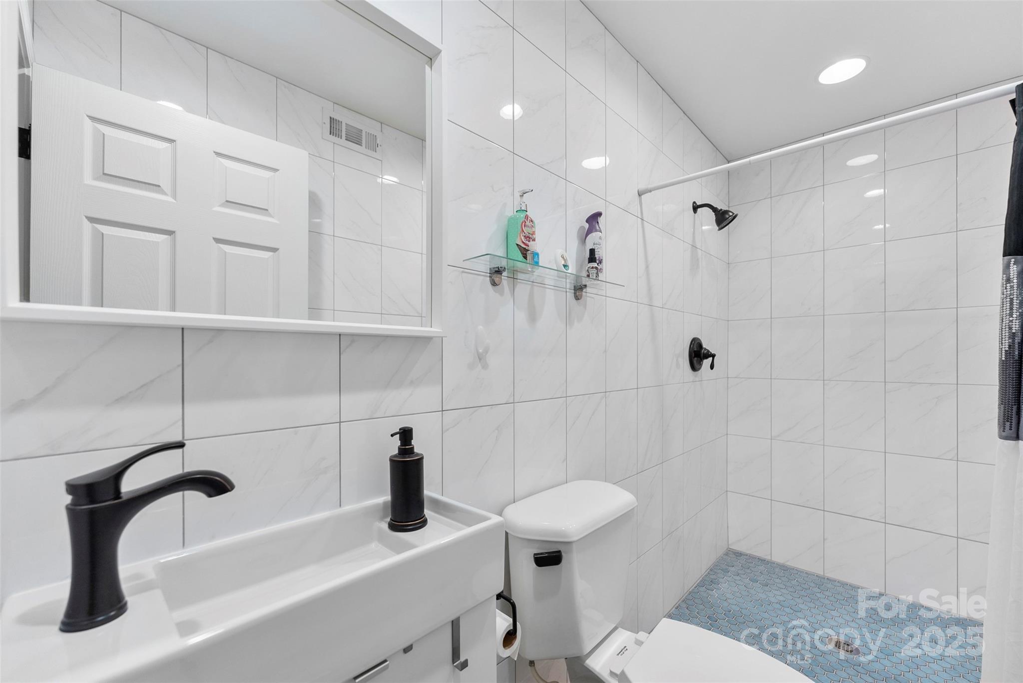 1822 North New Hope Road Gastonia, NC 28054 - Photo 13 of 47 a bathroom with a sink a toilet and shower