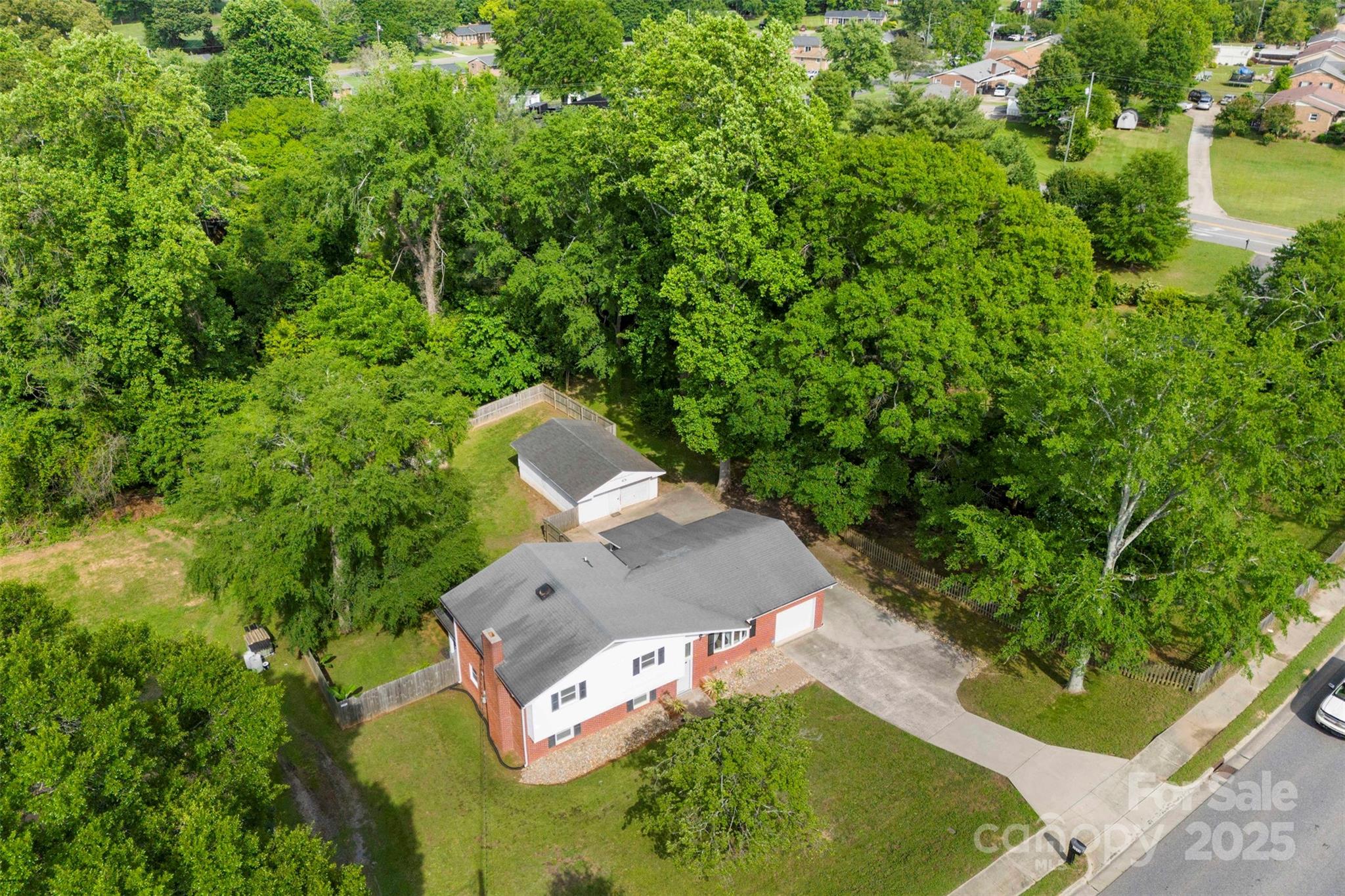1822 North New Hope Road Gastonia, NC 28054 - Photo 3 of 47 an aerial view of a house with a yard and large trees